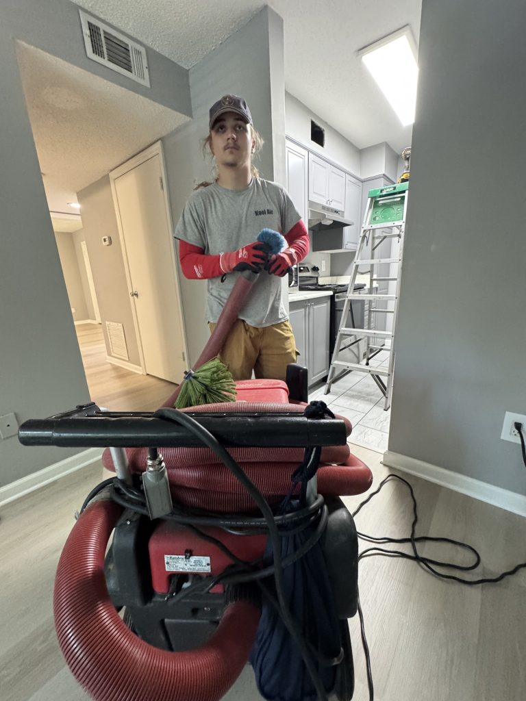 Kool Air technician preparing equipment for air duct cleaning in a Palm Coast FL home