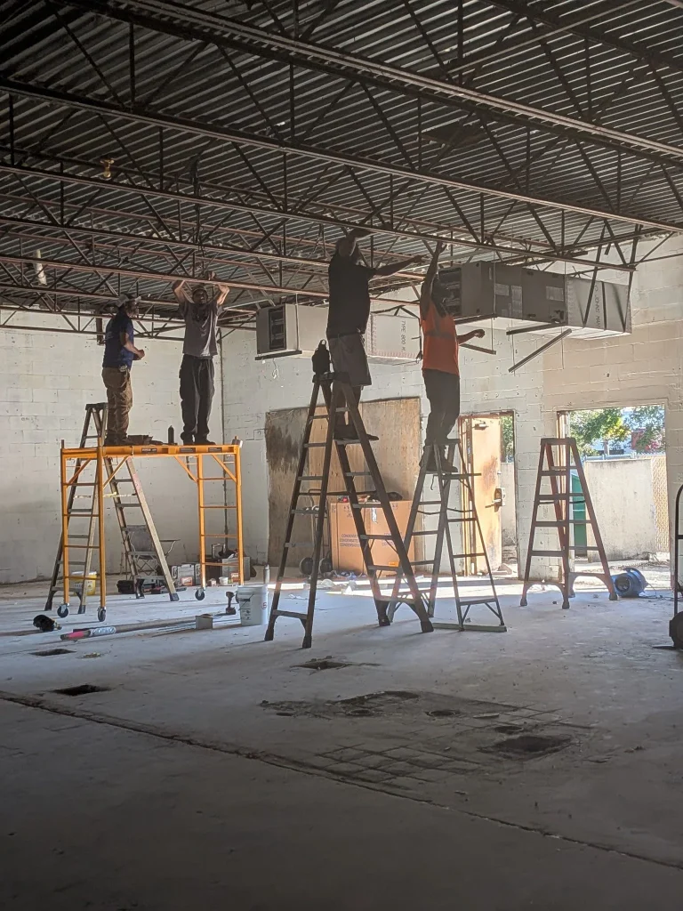 HVAC technicians installing commercial ventilation systems